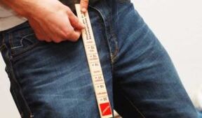 Man measuring penis with ruler